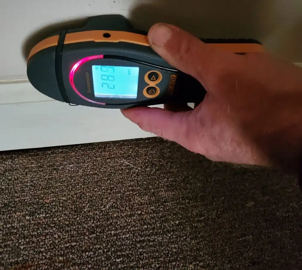 Moisture detection at baseboard during Storm Damage Restoration in Warrington